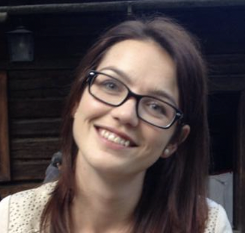 woman with glasses smiling